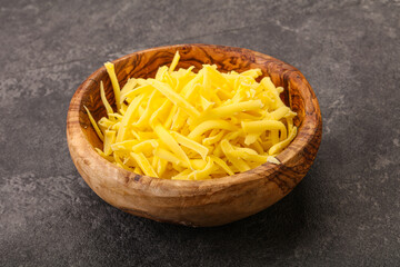 Shredded yellow cheese in the bowl
