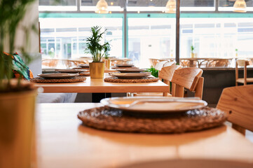 detail of ready-to-eat tables in empty rustic restaurant