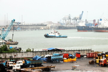 Seagoing vessels, tugboats at the port under cargo operations and underway. Paradeep, India,...