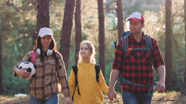 Happy Family Are Running On Hike Trip. Teamwork Family Hiking In Nature. Parents With Child Hiking Adventure. Group Of People Run The Field At Sunset. Friendly Family Summer Vacation Together.