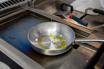 Padella con olio e aglio su piastra rovente