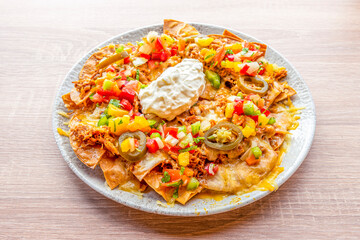 Corn nachos with cream cheese, pulled pork, sliced jelly beans, tricolor peppers and gratin cheddar...