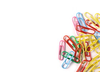 Colorful paperclips isolated on white background, top view