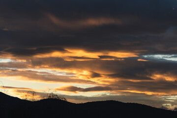 sunset sky with pink and orange clouds over the mountains