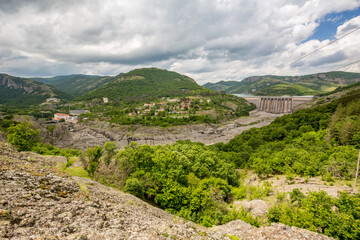 Fototapeta na wymiar Studen Kladenets water dam wall panoramic view, scenery cloudy sky, Southern Bulgaria