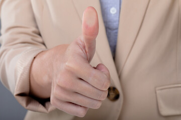 Midsection of caucasian businesswoman touching virtual interface on grey background