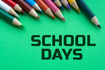 Colorful pencil crayons on a green background, School Days