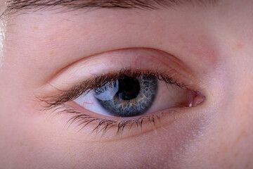 Obraz premium Close up of blue eye of caucasian businesswoman