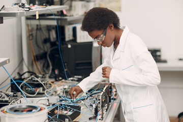 Scientist african american black woman working in laboratory and single photon decoder encoder...