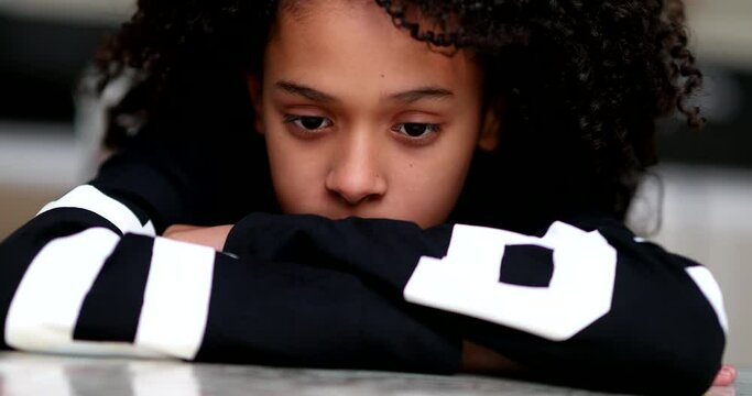 Pensive little girl child, thoughtful sad emotion