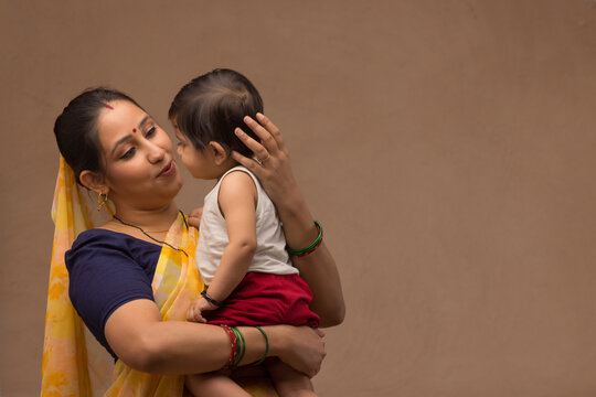 A woman holding her baby with affection.