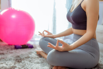 Fototapeta na wymiar crop photo of woman's hand lay on knees like lotus yoga with pink yoga exercise balloons lay on floor near window 