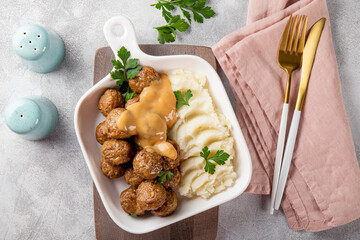 Traditional swedish meatballs with creamy sauce and mashed potatoes on gray background top view