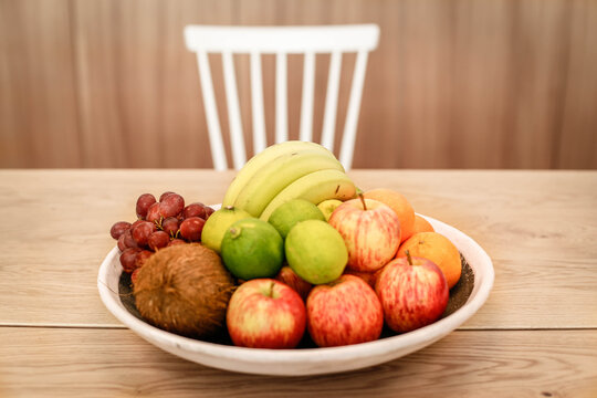 A bowl of juicy fruits sits on a table.
