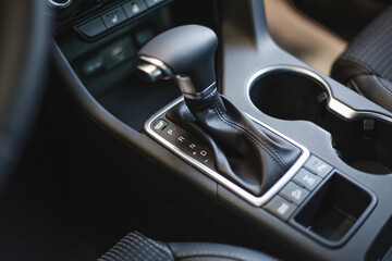 Fototapeta na wymiar car cup holders between back seats, close up view, luxury car interior