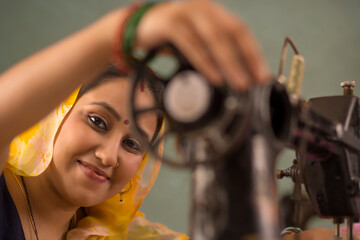 Fototapeta na wymiar A woman working with a sewing machine.