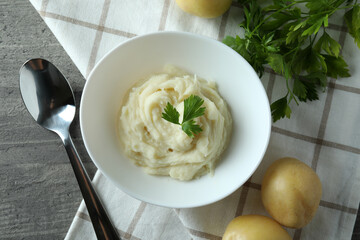Concept of tasty eating with mashed potatoes on gray textured table