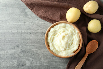 Concept of tasty eating with mashed potatoes on gray textured table