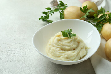 Concept of tasty eating with mashed potatoes on white textured table