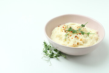 Plate of mashed potatoes on white background