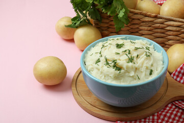Concept of tasty eating with mashed potatoes on pink background