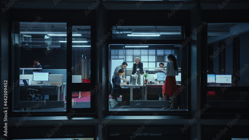Poster shot from outside the window: businessmen and businesswomen working in the office. managers and spec