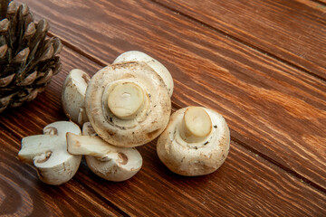 side view of fresh mushrooms on rustic wooden background with copy space