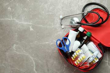 First aid medical kit on gray textured background