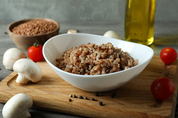 Concept of tasty eating with buckwheat on gray textured table