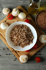 Concept of tasty eating with buckwheat on gray textured table