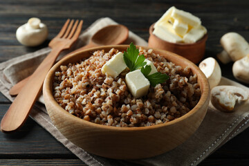 Concept of tasty eating with buckwheat on wooden table