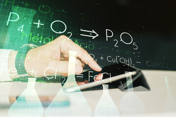 Creative chemistry concept with finger clicks on a digital tablet on background. Multiexposure