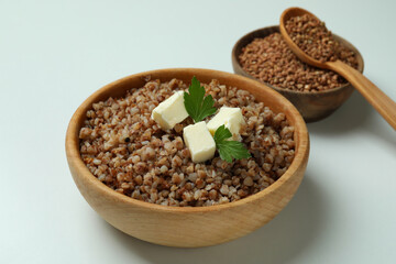 Concept of tasty eating with buckwheat on white background