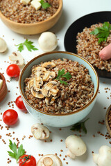 Concept of tasty eating with buckwheat on white background
