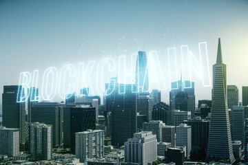 Fototapeta na wymiar Double exposure of abstract virtual blockchain technology hologram on San Francisco city skyscrapers background. Research and development decentralization software concept