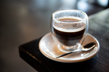 Hot americano coffee on table in cafe