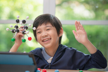 child constructing molecular model  in science classroom
