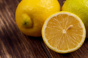 side view of fresh ripe lemons on rustic background