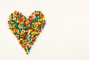 Colorful heart shape of different multicolored sprinkles