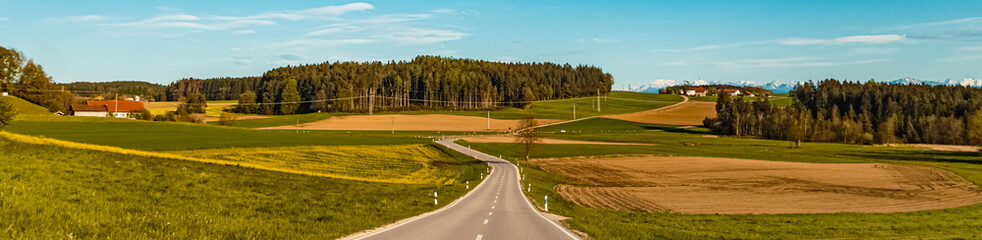 Beautiful spring view on a sunny day with the alps in the background near Schnaitsee, Bavaria, Germany