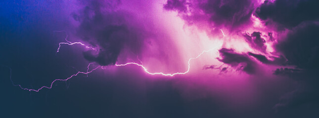 Thunderstorm lightning in dramatic sky in purple and blue