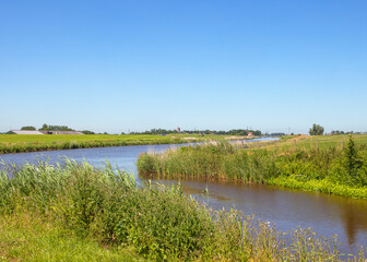 Dutch landscape with canal and village