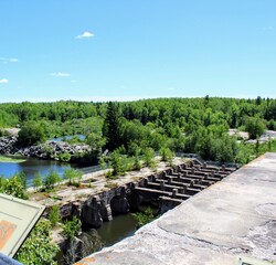 Panoramic view of the former hydroelectric power station. Pinawa Dam. River, forest, sky in the background. 