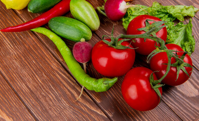 side view of fresh vegetables ripe tomatoes cucumbers green chili peppers and radish on wooden rustic background