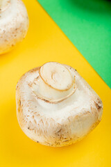 side view of fresh white mushrooms isolated on yellow background