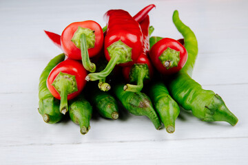 side view of green and red hot chili peppers isolated on white background