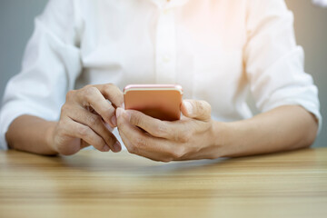 Closeup businessman hand touch screen on smart phone, marketing technology and business concept,...