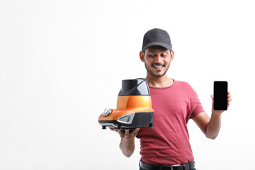 young indian electrician showing smartphone with mixer