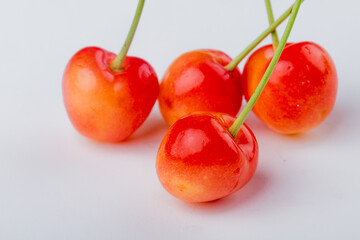 side view of ripe rainier cherries isolated on white background