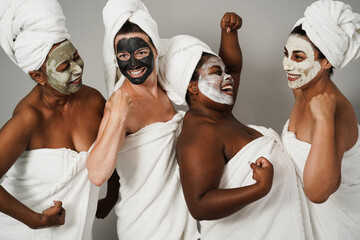 Multigenerational women having fun wearing face beauty mask - Skin care therapy and female power -...